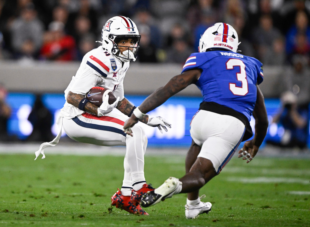 Arizona wide receiver Kris Hutson (4) tries to get past SMU safety Ahmaad Moses (3) during the first half of the Holiday Bowl NCAA college football game Friday, Jan. 2, 2026, in San Diego. (AP Photo/Denis Poroy)