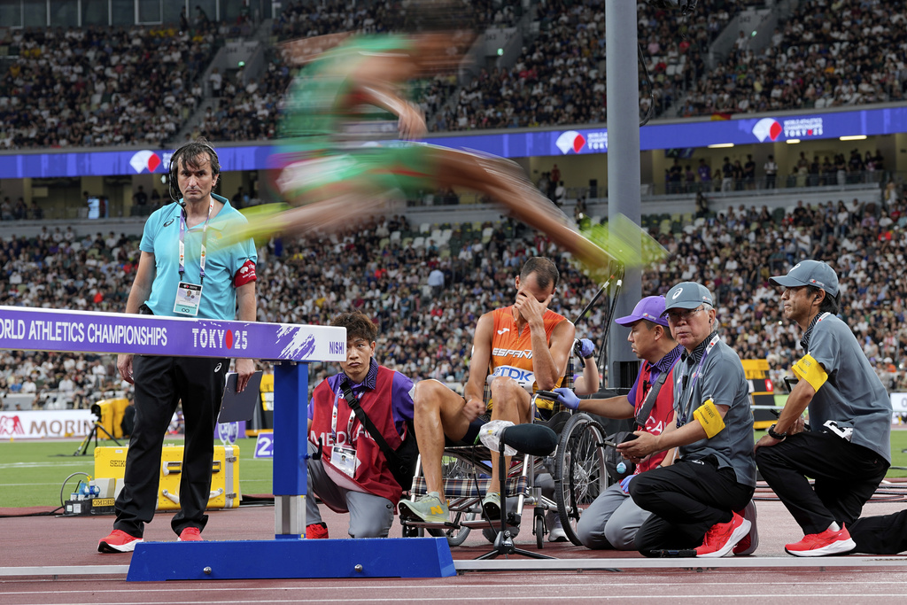 Spain's Daniel Arce reacts as other athletes compete after he fell during a men's 3,000 meters steeplechase heat at the World Athletics Championships in Tokyo, Saturday, Sept. 13, 2025. (AP Photo/Petr David Josek)