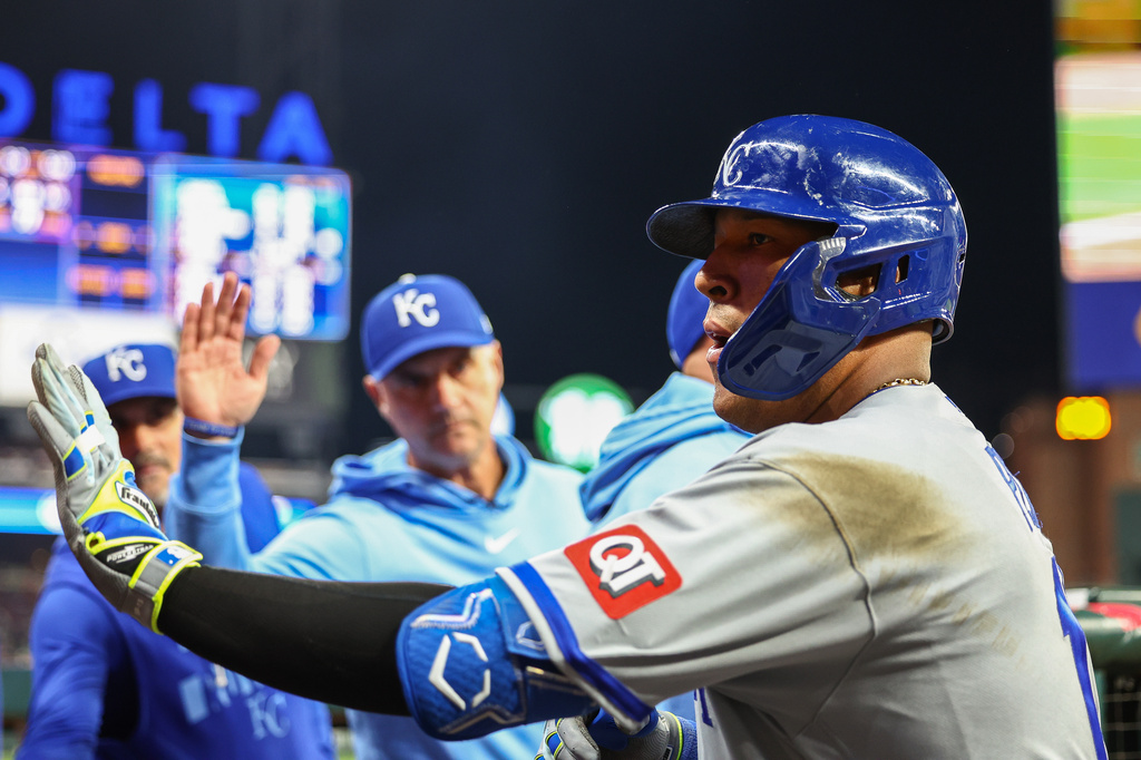 Kansas City Royals' Salvador Perez high-fives teammates in the dugout after hitting a solo home run in the seventh inning of a baseball game against the Atlanta Braves, Saturday, March 28, 2026, in Atlanta. (AP Photo/Colin Hubbard)