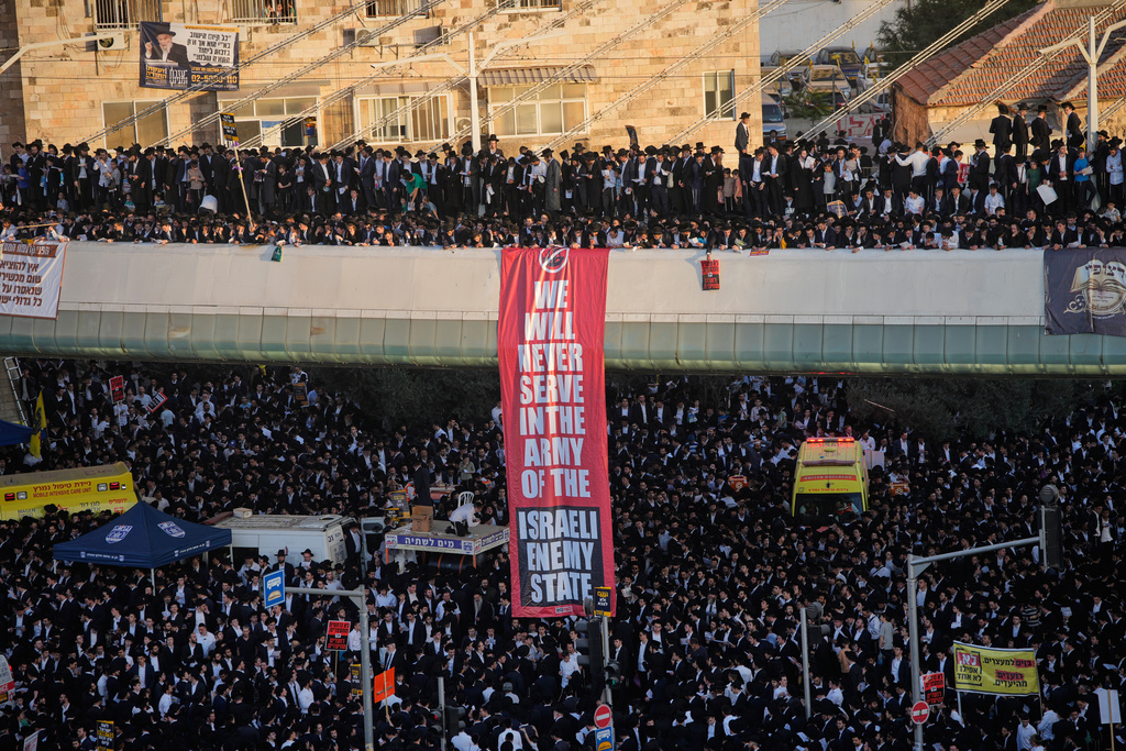 Ultra-Orthodox Jewish men protest against plans to force them to serve in the Israeli military, in Jerusalem, Thursday, Oct. 30, 2025. (AP Photo/Ohad Zwigenberg)