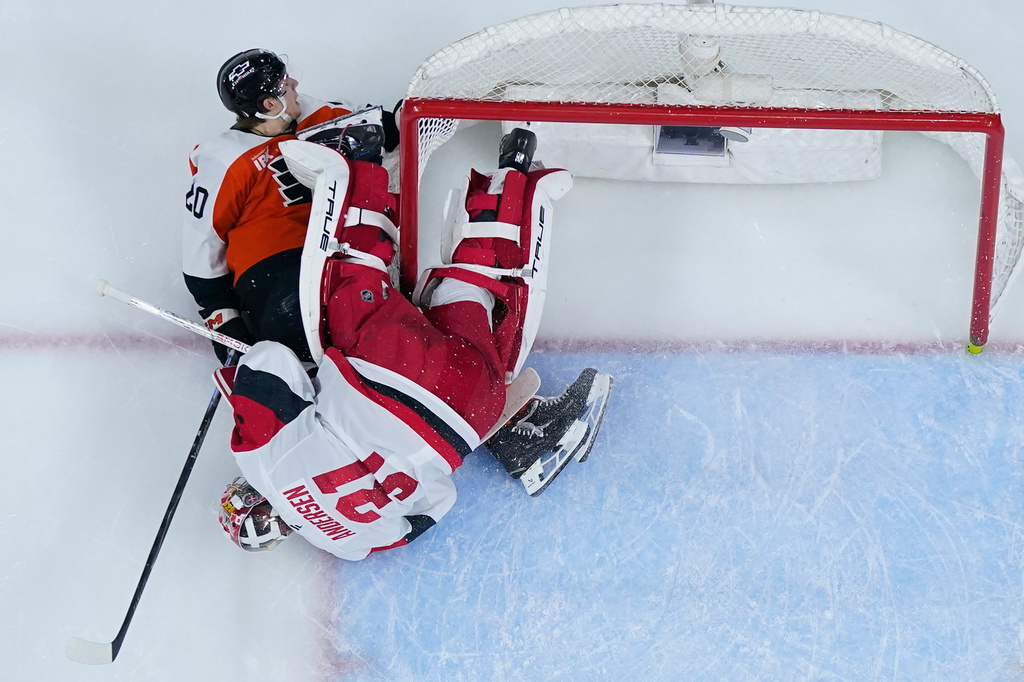 Philadelphia Flyers' Alex Bump, left, collides with Carolina Hurricanes' Frederik Andersen during the second period of Game 3 in the second round of the NHL hockey Stanley Cup playoffs, Thursday, May 7, 2026, in Philadelphia. (AP Photo/Matt Slocum)