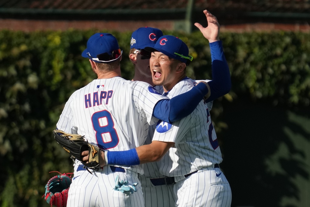 Chicago Cubs' Seiya Suzuki, Pete Crow-Armstrong and Ian Happ celebrate after Game 1 of a National League wild card baseball game against the San Diego Padres Tuesday, Sept. 30, 2025, in Chicago. (AP Photo/Nam Huh)