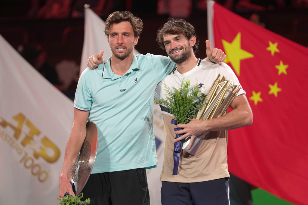 Winner Valentin Vacherot of Monaco, right, and Arthur Rinderknech of France, embrace on the winners podium after the final of the Shanghai Masters tennis tournament at Qizhong Forest Sports City Tennis Center, in Shanghai, China, Sunday, Oct. 12, 2025. (AP Photo/Andy Wong)
