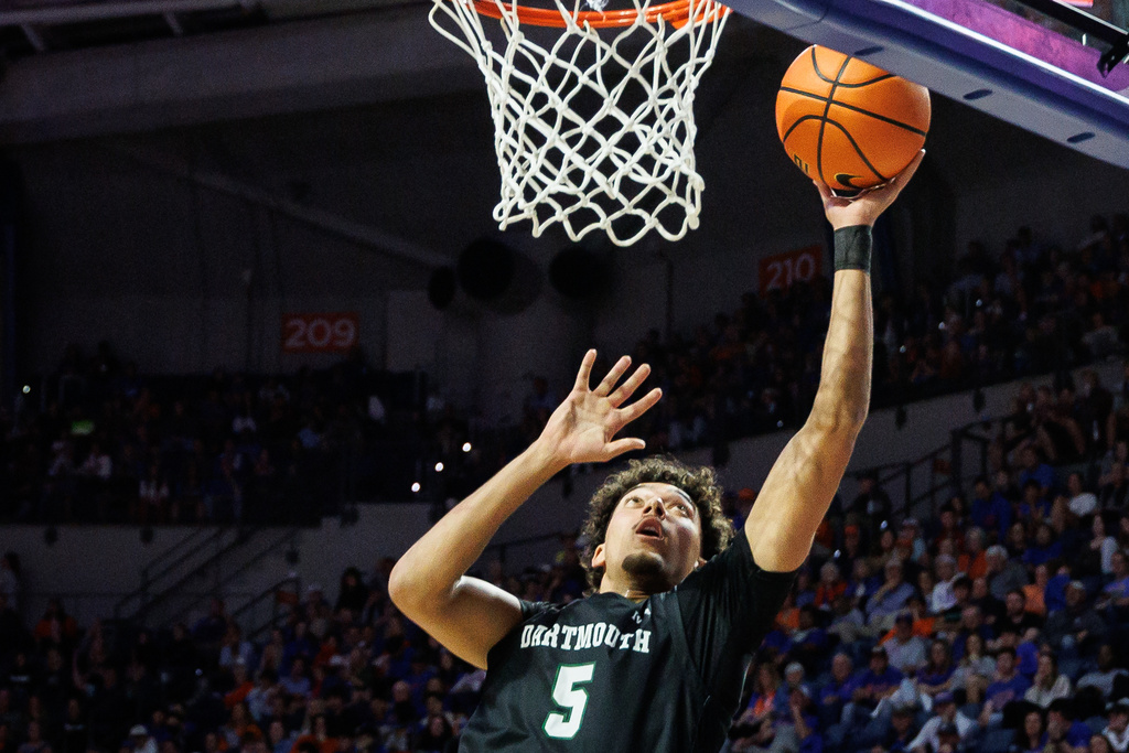 Dartmouth guard Cameron McNamee (5) makes a layup during the first half of an NCAA college basketball game against Florida, Monday, Dec. 29, 2025, in Gainesville, Fla. (AP Photo/Chris Watkins)
