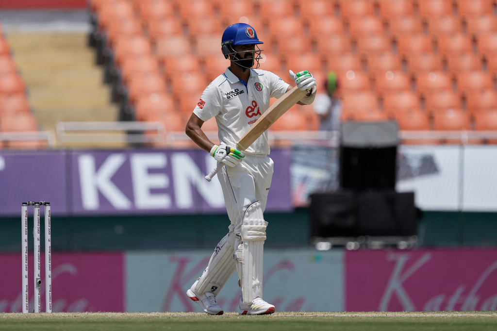 Afghanistan's Abdul Malik asks for the third umpire's review on day three of the cricket test match between Afghanistan and India in New Chandigarh, India, Monday, June 8, 2026. (AP Photo/Ashwini Bhatia)