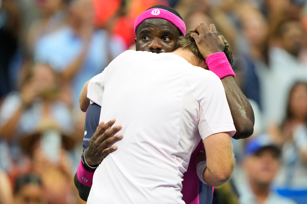 Frances Tiafoe, of the United States, right, and Alex Michelsen, of the United States, embrace after Tiafoe won their match during the quarterfinal round of the U.S. Open tennis championships, Tuesday, Sept. 8, 2026, in New York. (AP Photo/Yuki Iwamura)