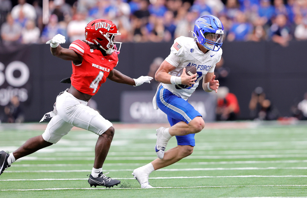 UNLV defensive back Andrew Powdrell (4) prepares to tackle Air Force quarterback Liam Szarka (9) on a quarterback keeper during the first half of an NCAA football game Saturday, Oct. 11, 2025, in Las Vegas. (Steve Marcus/Las Vegas Sun via AP)