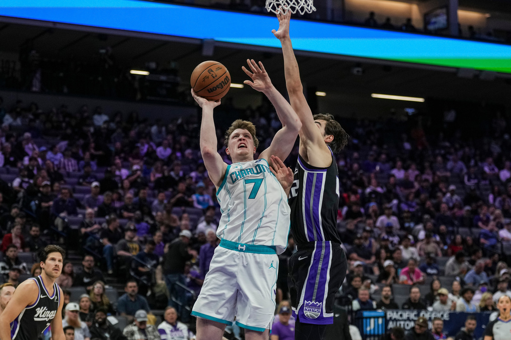 Charlotte Hornets guard Kon Knueppel (7) goes for a layup against Sacramento Kings center Maxime Raynaud (42) during the second half of an NBA basketball game, Wednesday, March 11, 2026, in Sacramento, Calif. (AP Photo/Justine Willard)