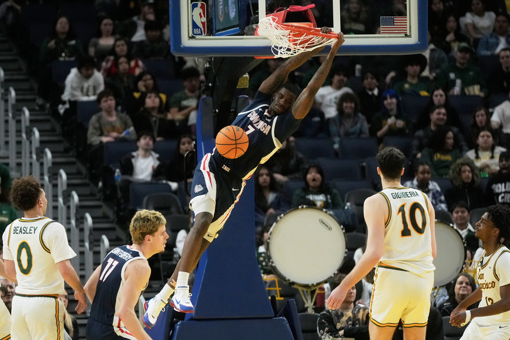 Gonzaga guard Tyon Grant-Foster, top, dunks against San Francisco during the second half of an NCAA college basketball game in San Francisco, Wednesday, Feb. 18, 2026. (AP Photo/Jeff Chiu)