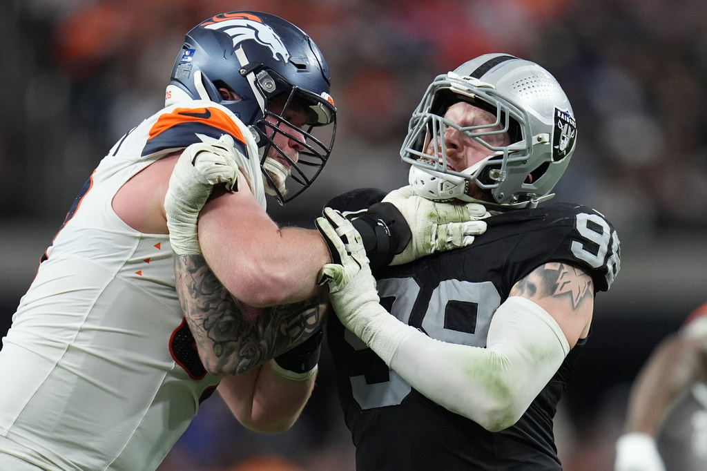 FILE - Denver Broncos offensive tackle Garett Bolles, left, blocks Las Vegas Raiders defensive end Maxx Crosby during the second half of an NFL football game in Las Vegas, Dec. 7, 2025. (AP Photo/Gregory Bull, File)