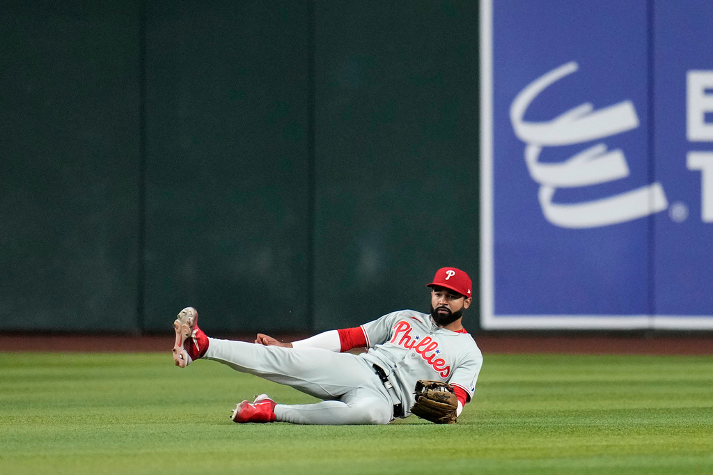 Philadelphia Phillies center fielder Derek Hill makes a diving catch on a line drive hit by Arizona Diamondbacks' Nolan Arenado during the fourth inning of a baseball game, Tuesday, Sept. 1, 2026, in Phoenix. (AP Photo/Ross D. Franklin)