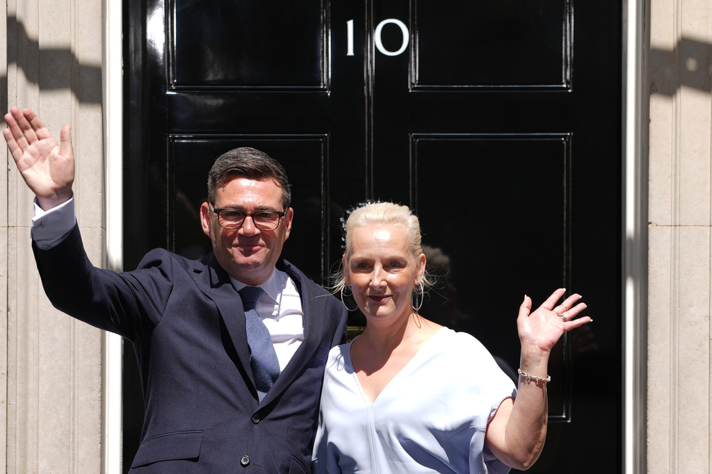 Britain's new Prime Minister Andy Burnham and his wife Marie-France van Heel wave as they arrive at 10 Downing Street in London, Monday, July 20, 2026.(AP Photo/Kirsty Wigglesworth)