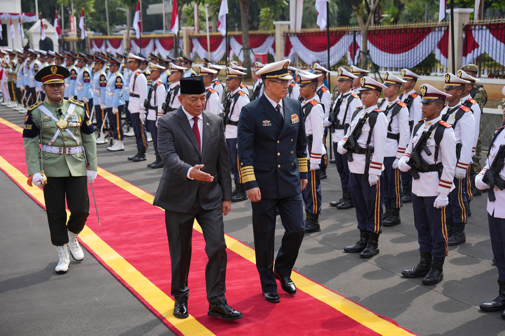 China's Defense Minister Dong Jun, right, and his Indonesian counterpart Sjafrie Sjamsoeddin inspect an honor guard during a welcoming ceremony ahead of their meeting in Jakarta, Indonesia, Friday, Aug. 21, 2026. (AP Photo/Dita Alangkara)