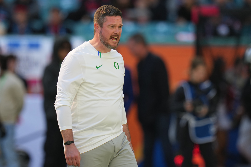 Oregon head coach Dan Lanning watches as players warm up for the Orange Bowl College Football Playoff quarterfinal game against Texas Tech, Thursday, Jan. 1, 2026, in Miami Gardens, Fla. (AP Photo/Lynne Sladky)