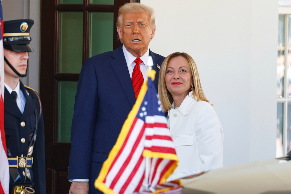 FILE - President Donald Trump, center, greets Italy's Prime Minister Giorgia Meloni, right, upon her arrival at the White House, April 17, 2025, in Washington. (AP Photo/Tom Brenner, File)