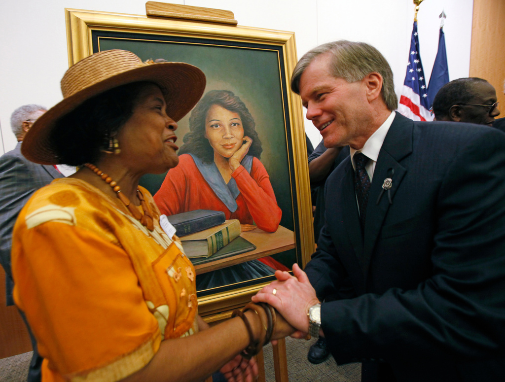 FILE - Joan Cobbs, left, sister of civil rights legend Barbara Johns, shakes hands with Virginia Gov. Bob McDonnell, right, after a portrait of Barbara Johns, center, was unveiled in the Virginia State Capitol in Richmond, Va., Sept. 17, 2010. (Bob Brown/Richmond Times-Dispatch via AP)