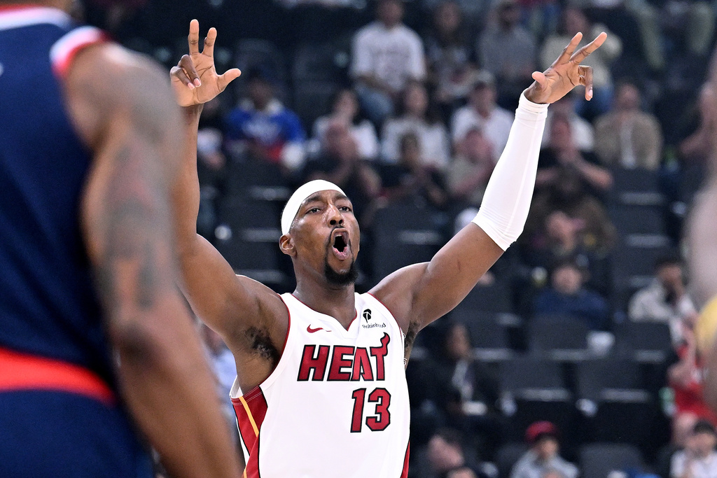 Miami Heat forward Bam Adebayo (13) celebrates his three-pointer against the Los Angeles Clippers during the first half of an NBA basketball game, Monday, Nov. 3, 2025, in Los Angeles. (AP Photo/Wally Skalij)