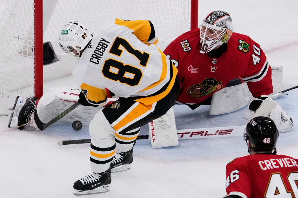 Chicago Blackhawks goaltender Arvid Soderblom (40) saves a shot by Pittsburgh Penguins center Sidney Crosby (87) during the second period of an NHL hockey game in Chicago, Sunday, Dec. 28, 2025. (AP Photo/Nam Y. Huh)