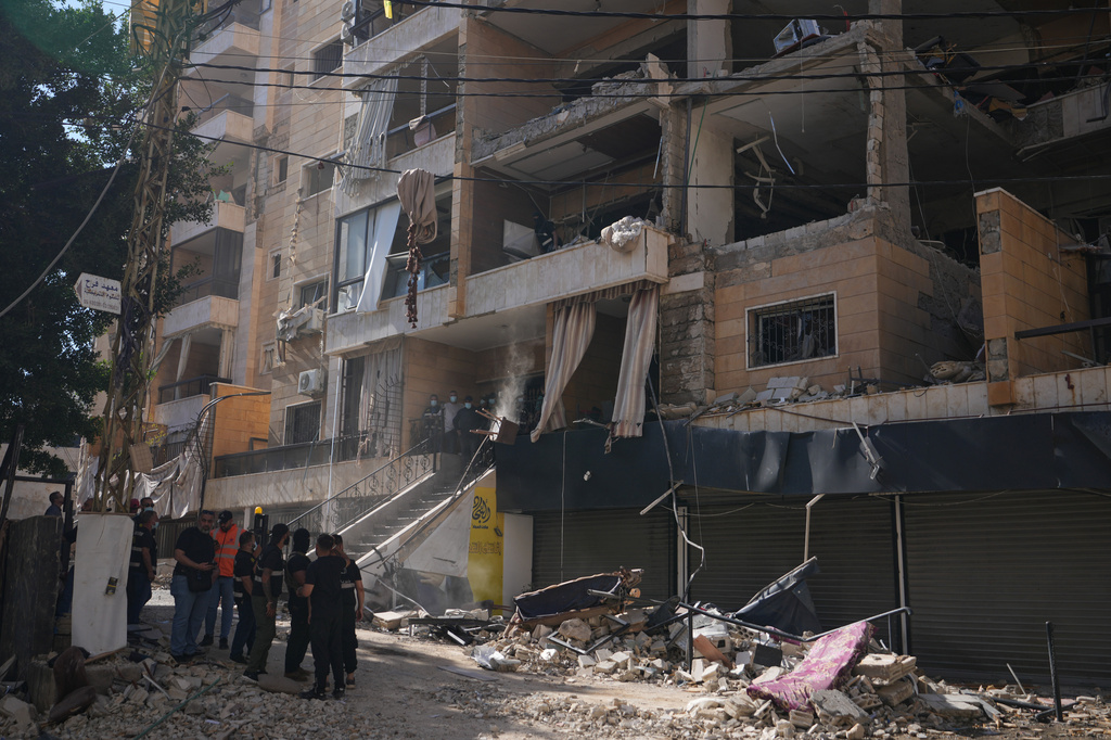 Lebanese security officers gather at the site where an Israeli airstrike hit a building in Dahiyeh, Beirut's southern suburb, Lebanon, Sunday, June 7, 2026. (AP Photo/Hassan Ammar)