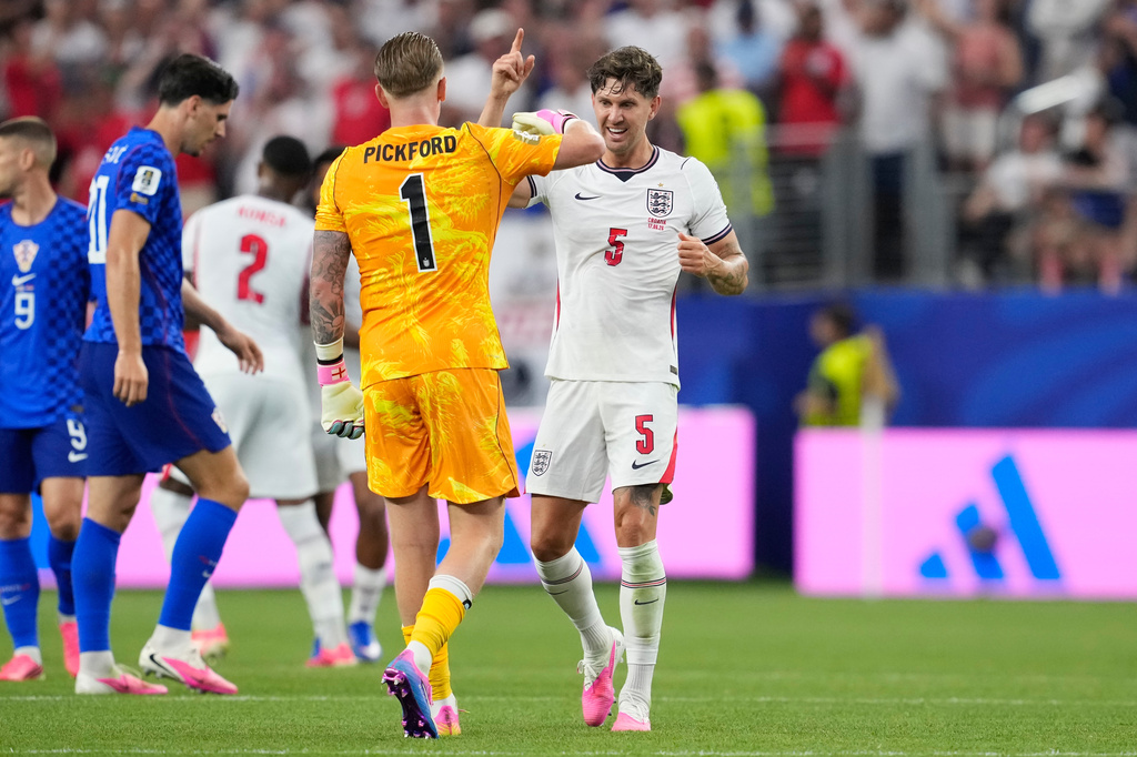 England's John Stones (5) and England goalkeeper Jordan Pickford (1) celebrate their team's fourth goal by England's Marcus Rashford during the World Cup Group L soccer match between England and Croatia in Arlington, Texas, near Dallas, Wednesday, June 17, 2026. (AP Photo/Tony Gutierrez)