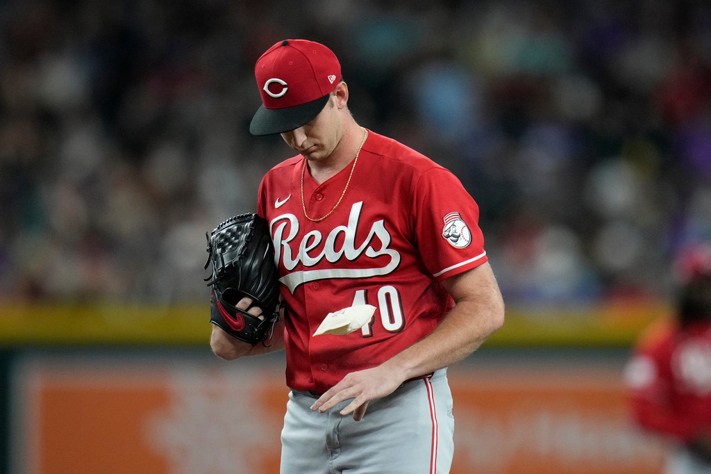 Cincinnati Reds starting pitcher Nick Lodolo flips the rosin bag during the first inning of a baseball game against the Arizona Diamondbacks, Friday, Aug. 21, 2026, in Phoenix. (AP Photo/Ross D. Franklin)
