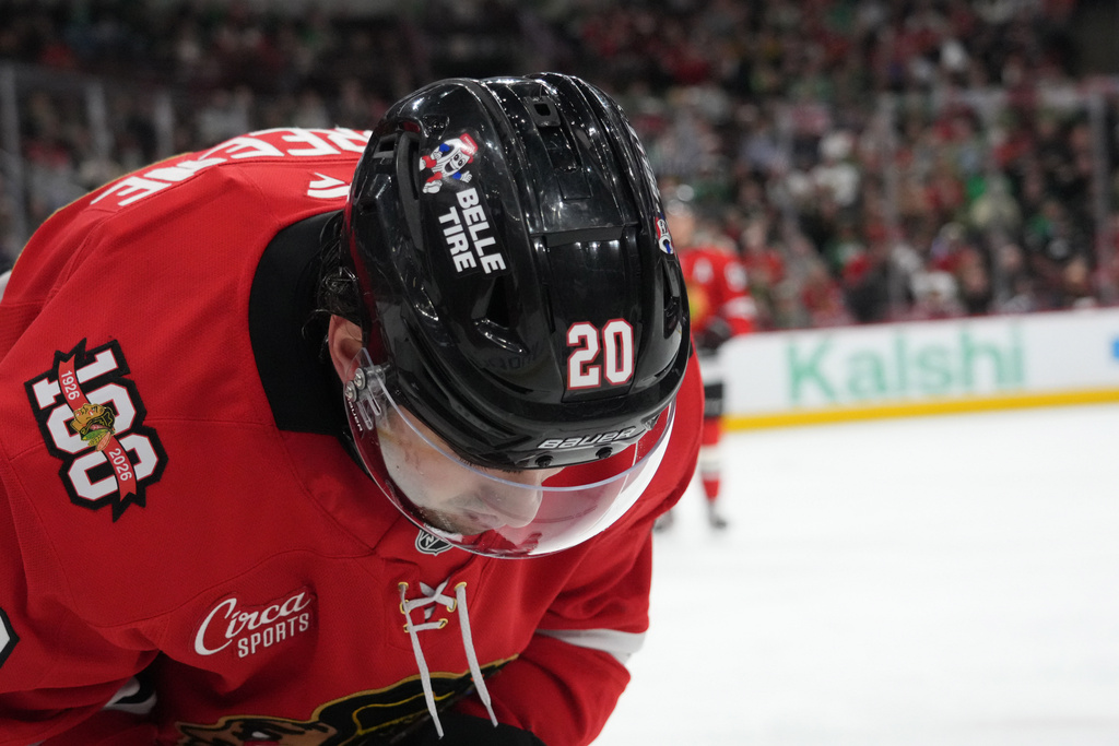 Chicago Blackhawks center Ryan Greene (20) bends over after being struck in the face against the Minnesota Wild during the first period of an NHL hockey game Tuesday, March, 17, 2026, in Chicago. (AP Photo/David Banks)