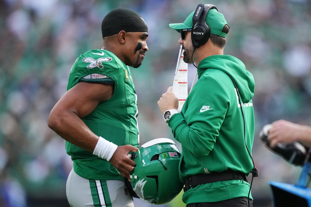Philadelphia Eagles quarterback Jalen Hurts (1) speaks with Eagles head coach Nick Sirianni during the first half of an NFL football game against the New York Giants on Sunday, Oct. 26, 2025, in Philadelphia. (AP Photo/Matt Slocum)