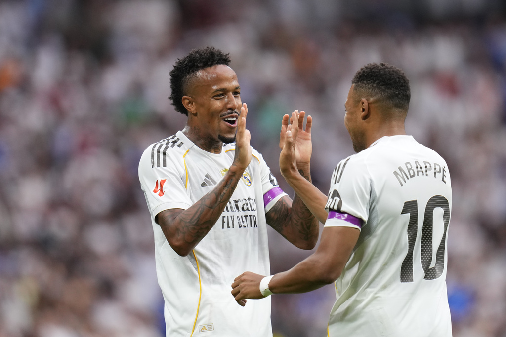 Real Madrid's Eder Militao, left, celebrates with Kylian Mbappe after scoring the opening goal during the Spanish La Liga soccer match between Real Madrid and Espanyol at the Santiago Bernabeu stadium in Madrid, Spain, Saturday, Sept. 20, 2025. (AP Photo/Manu Fernandez)
