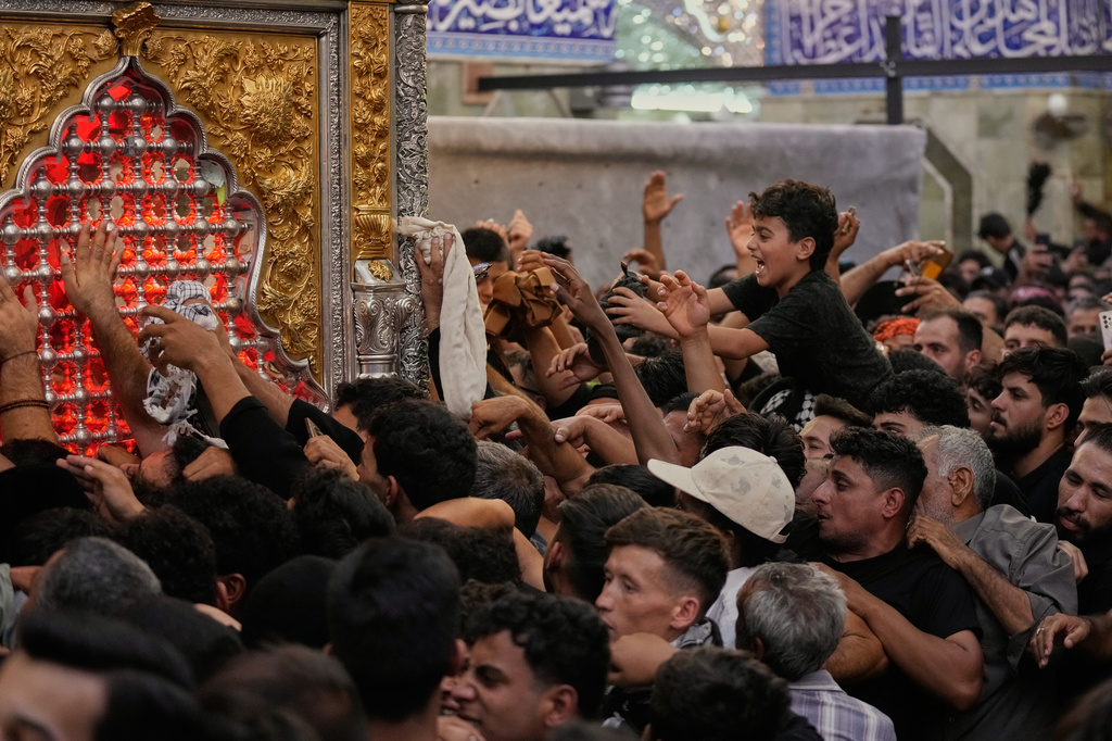 Shiite Muslim worshippers gather inside the holy shrine of Imam Abbas ahead of the Arbaeen festival in Karbala, Iraq, Sunday, Aug. 2, 2026. (AP Photo/Hadi Mizban)