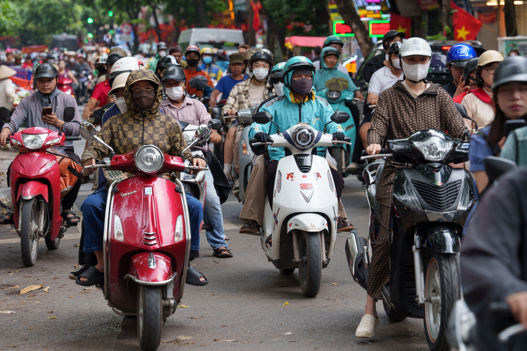CORRECTS TO CALL THE AREA THE OLD QUARTER - Vietnamese ride two-wheelers in the Old Quarter area in Hanoi, Vietnam, on Aug. 31, 2025. (AP Photo/Vincent Thian)
