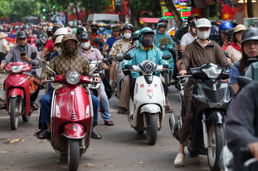 CORRECTS TO CALL THE AREA THE OLD QUARTER - Vietnamese ride two-wheelers in the Old Quarter area in Hanoi, Vietnam, on Aug. 31, 2025. (AP Photo/Vincent Thian) CORRECTS TO CALL THE AREA THE OLD QUARTER - Vietnamese ride two-wheelers in the Old Quarter area in Hanoi, Vietnam, on Aug. 31, 2025. (AP Photo/Vincent Thian)