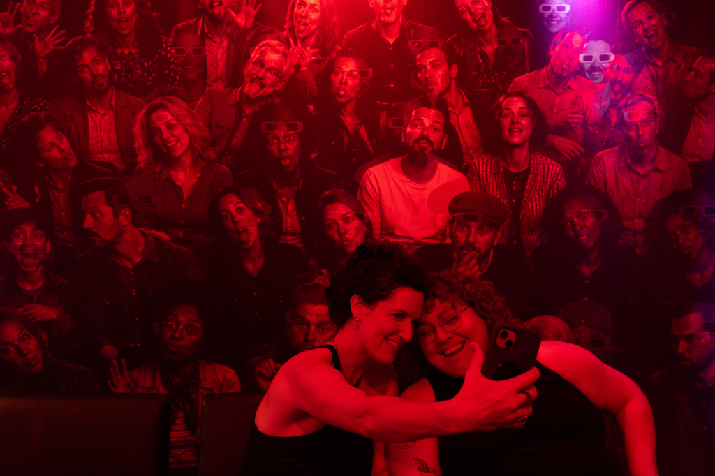 Ondrea Boggs, left, and Sharon Maxwell take a selfie with "We See You Too," an installation by artists Alon Cohen Raz and Miran Nudell, during the "Hospital of Emotions" exhibition inside a former hospital building in Los Angeles, Wednesday, July 22, 2026. (AP Photo/Jae C. Hong)