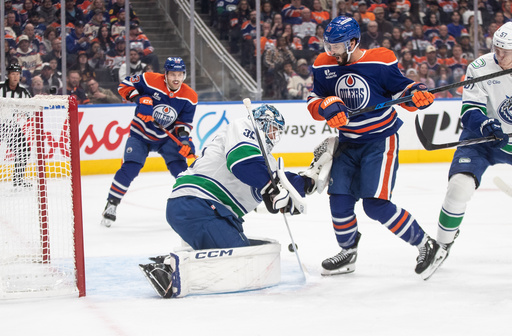 Vancouver Canucks goalie Thatcher Demko (35) makes the save against Edmonton Oilers' Adam Henrique (19) during the second period of an NHL hockey game in Edmonton, Alberta, Saturday, Oct. 11, 2025. (Jason Franson/The Canadian Press via AP) Vancouver Canucks goalie Thatcher Demko (35) makes the save against Edmonton Oilers' Adam Henrique (19) during the second period of an NHL hockey game in Edmonton, Alberta, Saturday, Oct. 11, 2025. (Jason Franson/The Canadian Press via AP)