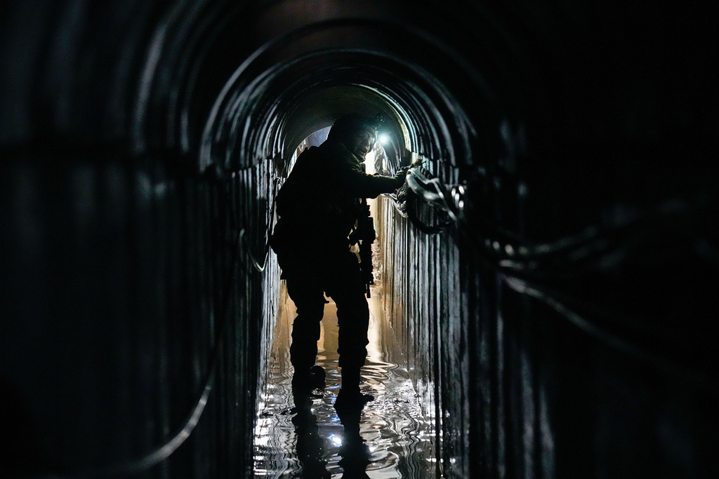 Israeli Lt. Col. Ido, whose last name was redacted by the military, walks inside a tunnel underneath the UNRWA compound, where the military discovered tunnels in the main headquarters of the U.N. agency that the military says Hamas militants used to attack its forces during a ground operation in Gaza, Thursday, Feb. 8, 2024. (AP Photo/Ariel Schalit)