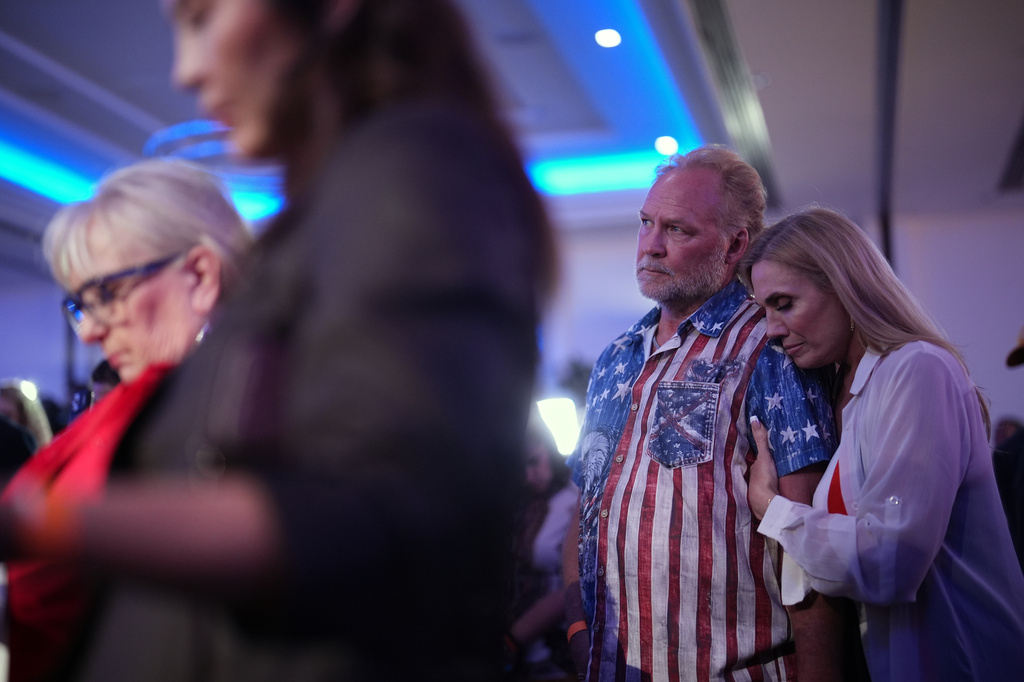 Kimberly Henak, right, embraces Randy Henak during a moment of prayer at an election night event for California gubernatorial candidate Steve Hilton, Tuesday, June 2, 2026, in Huntington Beach, Calif. (AP Photo/Gregory Bull)