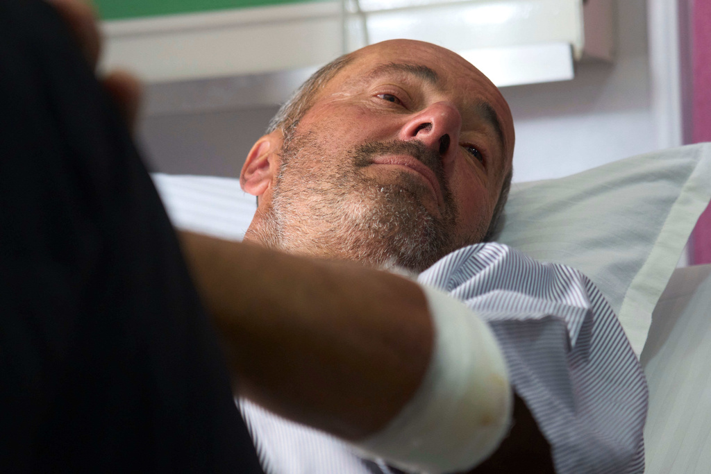 Didier Armand, a survivor of an avalanche on Mount Yalung Ri, takes rest after being rescued and airlifted to a hospital in Kathmandu, Nepal, Tuesday, Nov. 4, 2025. (AP Photo/Niranjan Shrestha)