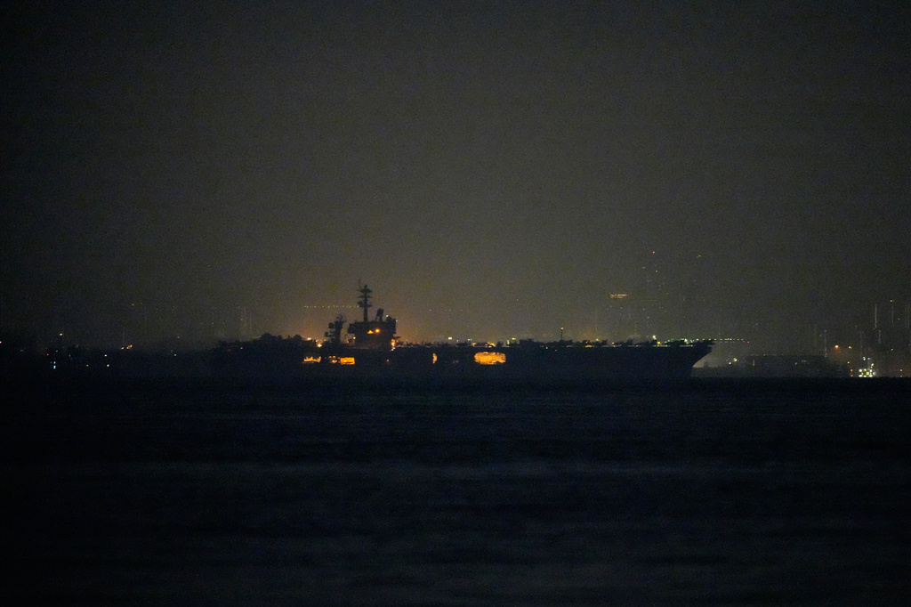 The U.S. Navy aircraft carrier USS Abraham Lincoln sails past Singapore as seen from Batam, Indonesia, Sunday, Aug. 30, 2026. (AP Photo/Dita Alangkara)
