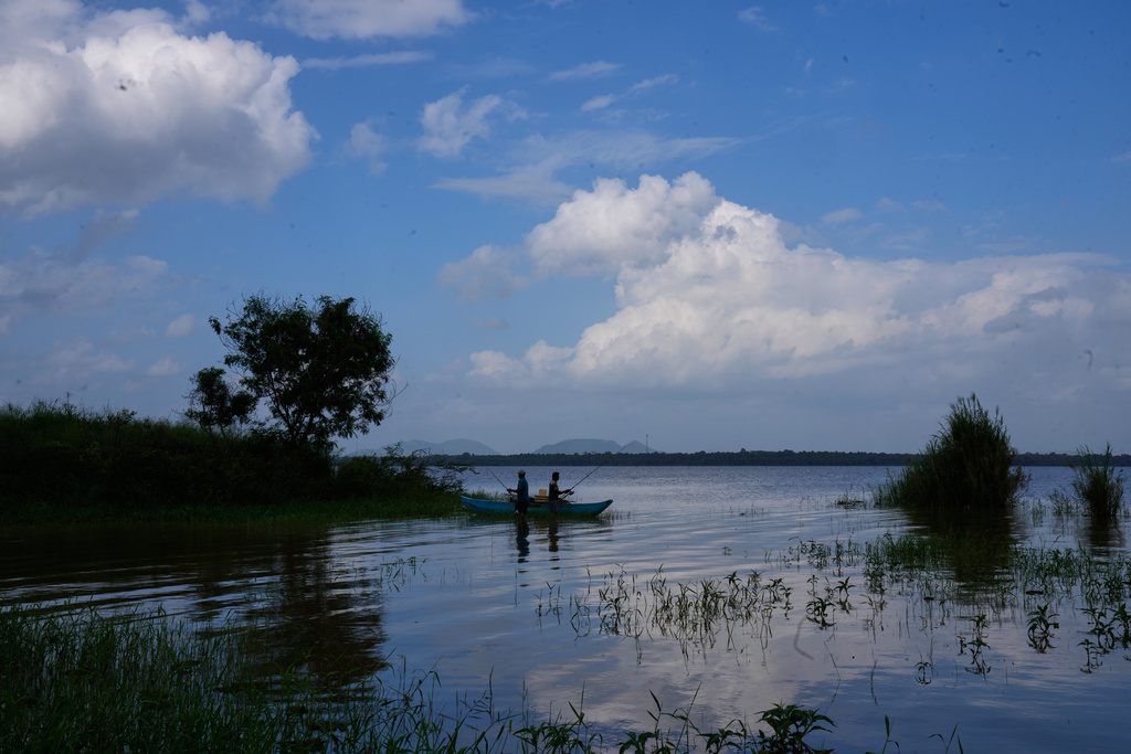 Ilshan Madhuthisara, left, and Ranjith Kumara fish for giant snakeheads at the Deduru Oya resovoire, in Walpaluwa village, Sri Lanka, Wednesday, Oct, 29, 2025. (AP Photo/Eranga Jayawardena)