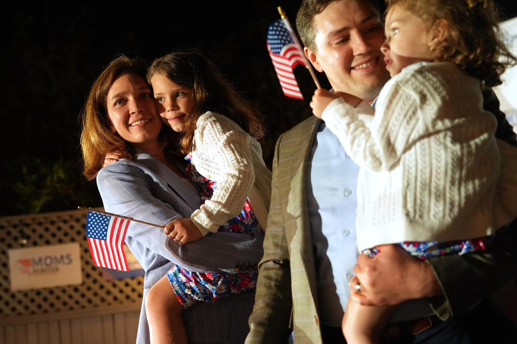 From left, Rebecca Bennett, Democratic candidate for New Jersey's 7th Congressional District, holds her daughter Rosie, alongside her husband Alex Hydrean and daughter Millie during a primary election night watch party after winning the Democratic nomination Tuesday, June 2, 2026, in Bridgewater, N.J. (AP Photo/Ryan Murphy)