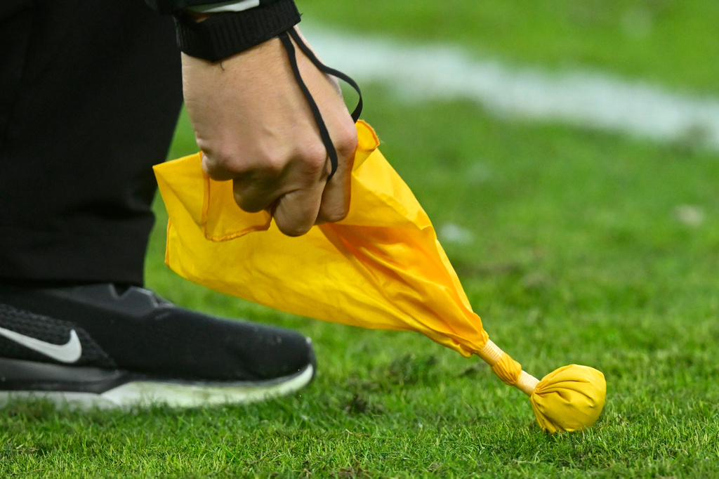 FILE - A referee picks up a penalty flag during an NFL football game between the Cleveland Browns and the Kansas City Chiefs, Sunday, Dec. 15, 2024, in Cleveland. (AP Photo/David Richard, File)