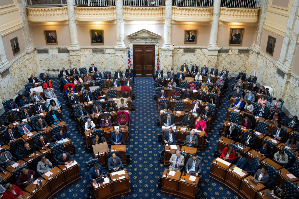 FILE - Delegates gather on the floor in the House Chamber for a session of the Maryland General Assembly at the State Capitol in Annapolis, Md, Wednesday, Jan 11, 2024. (AP Photo/Bryan Woolston, File)