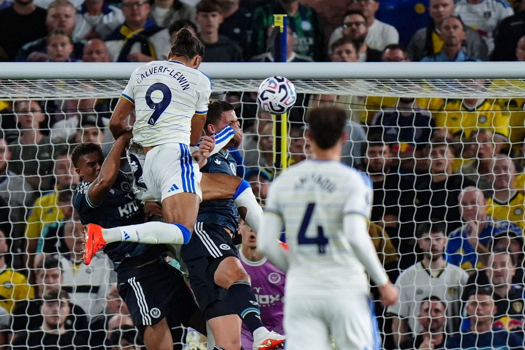 Leeds United's Dominic Calvert-Lewin, top, scores during the English Premier League soccer match between Leeds United and Newcastle United in Leeds, England, Monday Sept. 14, 2026. (Annabel Lee-Ellis/PA via AP)
