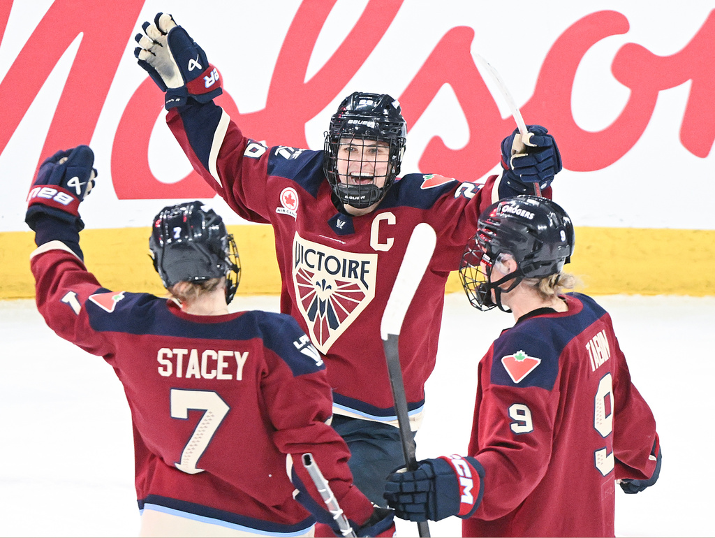 Montreal Victoire's Marie-Philip Poulin (29) celebrates with teammates Laura Stacey (7) and Kati Tabin (9) after scoring against the Minnesota Frost during overtime in a PWHL hockey game in Laval, Quebec, Sunday, Jan. 4, 2026. (Graham Hughes/The Canadian Press via AP)