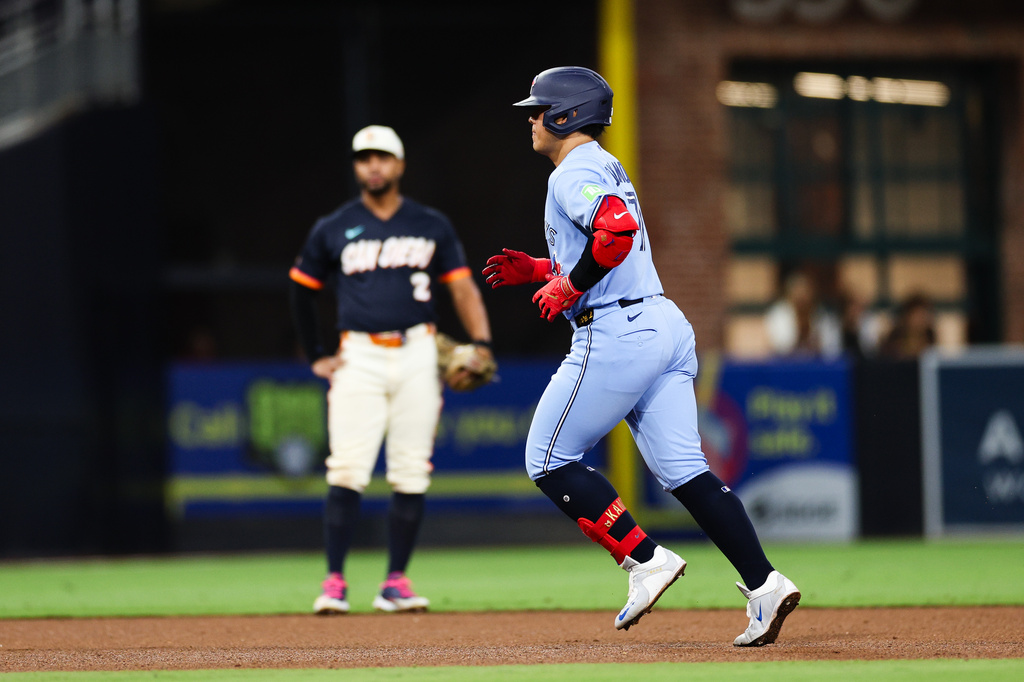 Toronto Blue Jays' Kazuma Okamoto, right, runs the bases past San Diego Padres' Xander Bogaerts, left, after hitting a three-run home run in the fifth inning of a baseball game Friday, July 10, 2026, in San Diego. (AP Photo/Derrick Tuskan)
