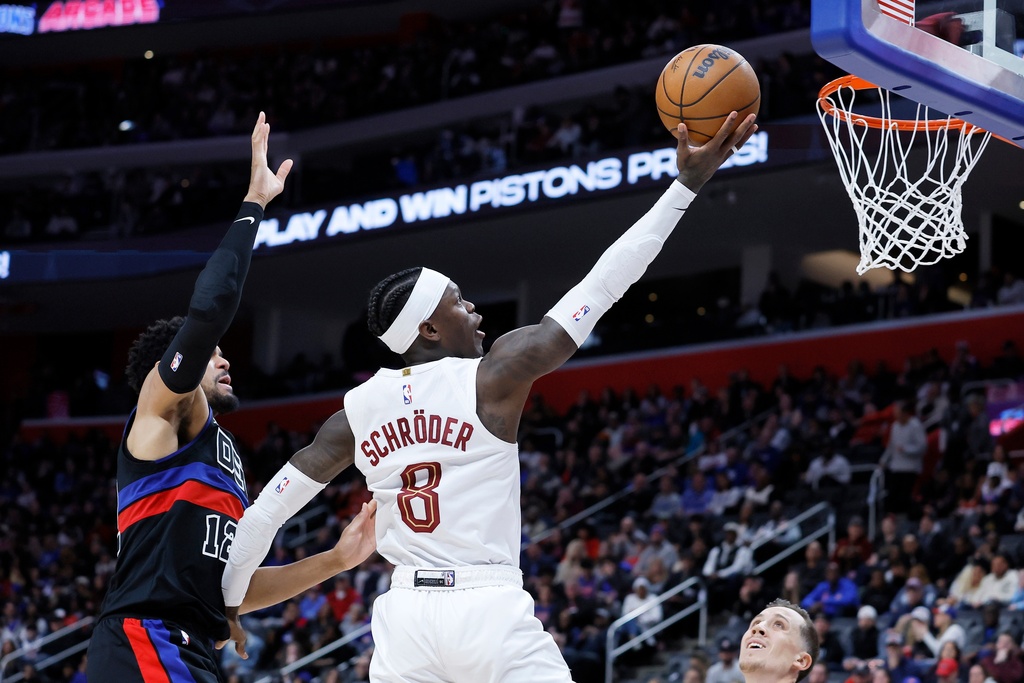 Cleveland Cavaliers guard Dennis Schroder (8) goes to the basket past Detroit Pistons forward Tobias Harris (12) during the second half of an NBA basketball game Friday, Feb. 27, 2026, in Detroit. (AP Photo/Duane Burleson)