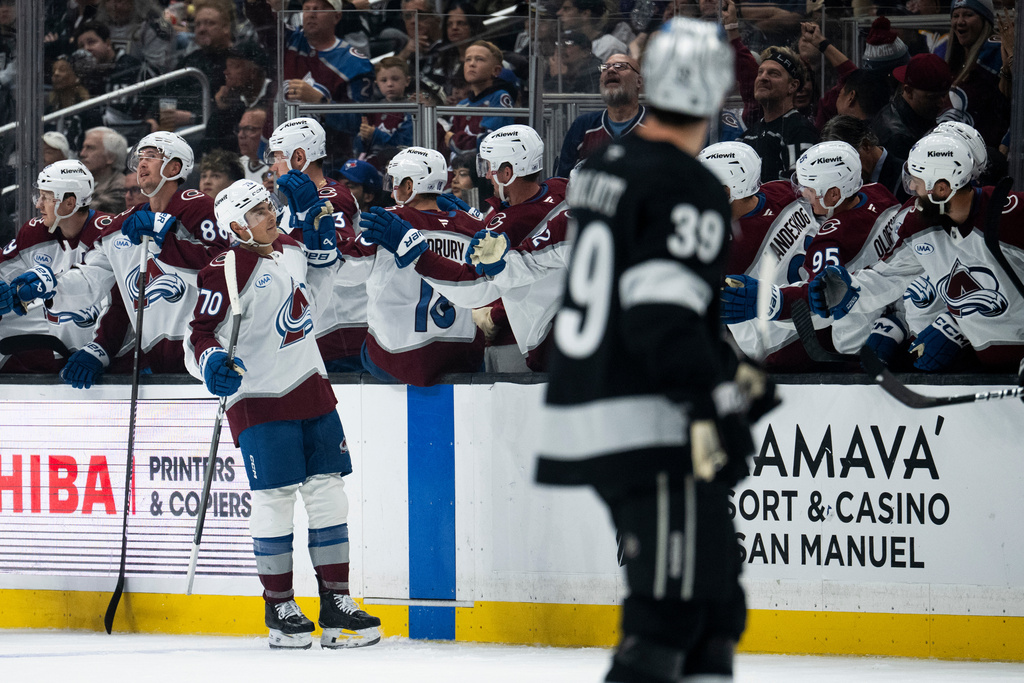 Colorado Avalanche defenseman Sam Malinski (70) celebrates his goal with the bench during the second period of an NHL hockey game against the Los Angeles Kings, Tuesday, Oct. 7, 2025, in Los Angeles. (AP Photo/Kyusung Gong)