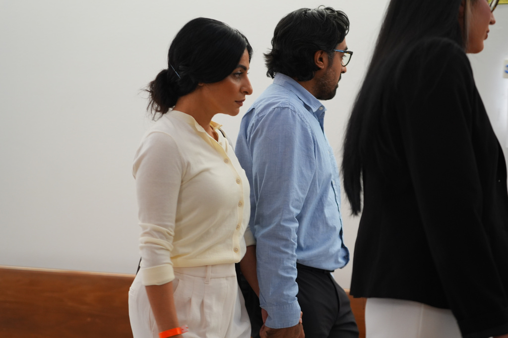 Nausheen Gilkar, left, and her husband Omar Ahmed arrive for a court hearing in Dallas, Tuesday, Aug. 25, 2026. (AP Photo/LM Otero)