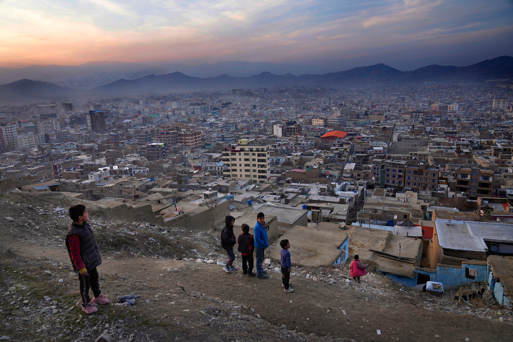 FILE - Boys stay on a hilltop overlooking Kabul, Afghanistan, Feb. 27, 2022. (AP Photo/Hussein Malla, File)