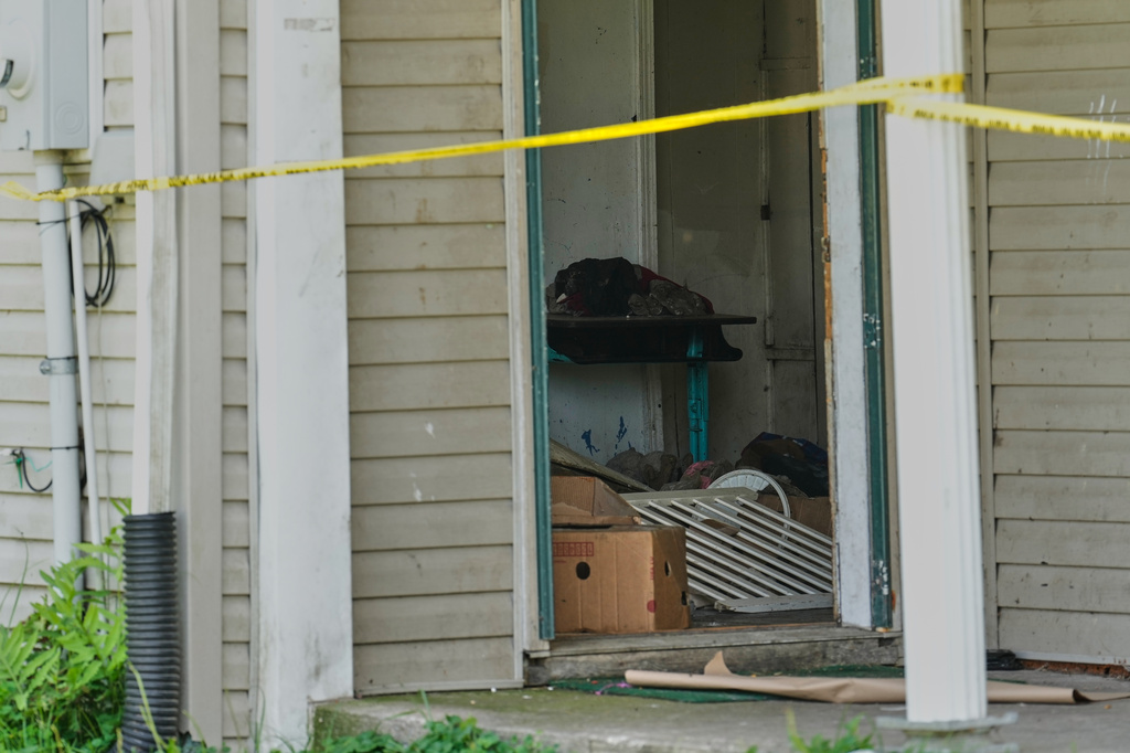 Items are seen beyond police tape in a home where authorities say they removed 16 children and arrested four adults in Hamden, Ohio, Wednesday, July 1, 2026. (AP Photo/Carolyn Kaster)