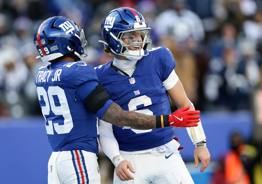 New York Giants running back Tyrone Tracy Jr. (29) and quarterback Jaxson Dart (6) celebrate after a touchdown against the Dallas Cowboys during the third quarter of an NFL football game, Sunday, Jan. 4, 2026, in East Rutherford, N.J. (AP Photo/Adam Hunger)
